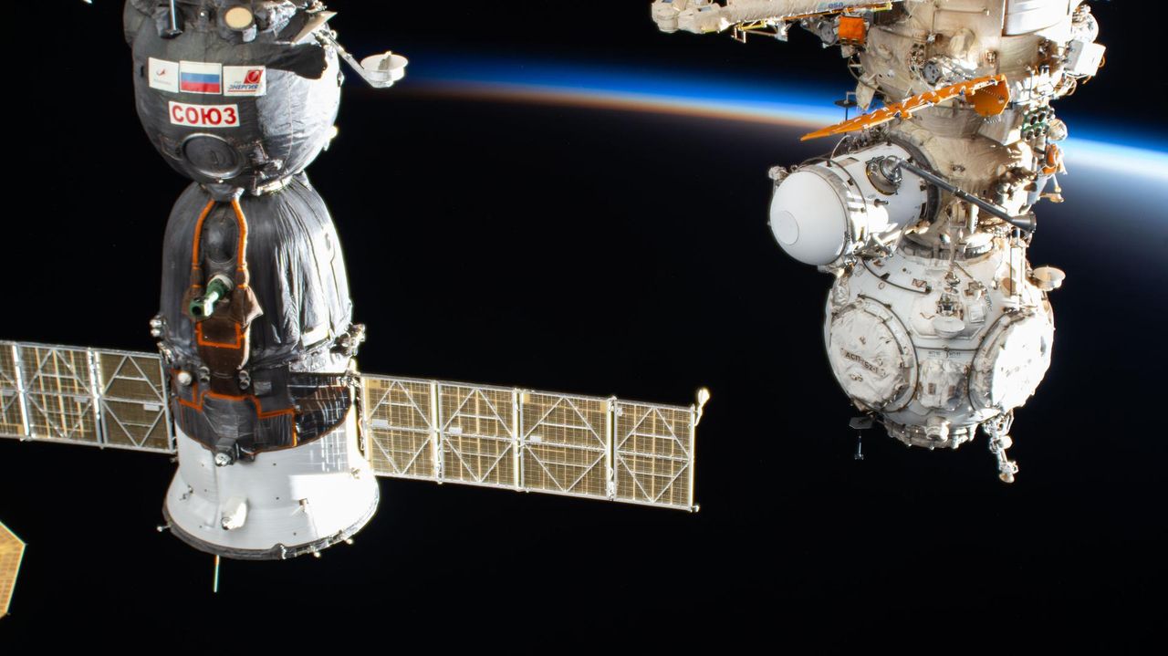 The International Space Station silhouetted against an orbital sunset